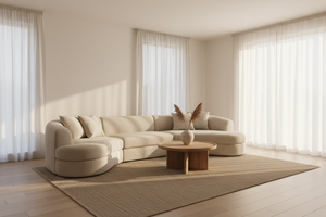 A softly lit neutral living room scene with a modern beige sectional, minimal styling, clean wall background, soft shadows, warm inviting atmosphere, high-end lifestyle photography, uncluttered composition.